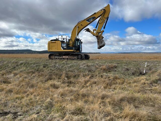 Excavator on the marsh near the YJ canal levee.