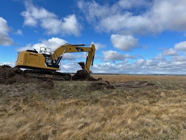 Excavator moving levee material.